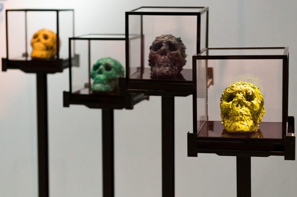 Small floral skull sculptures made from leather flowers displayed in glass cases at Lane Crawford Beijing