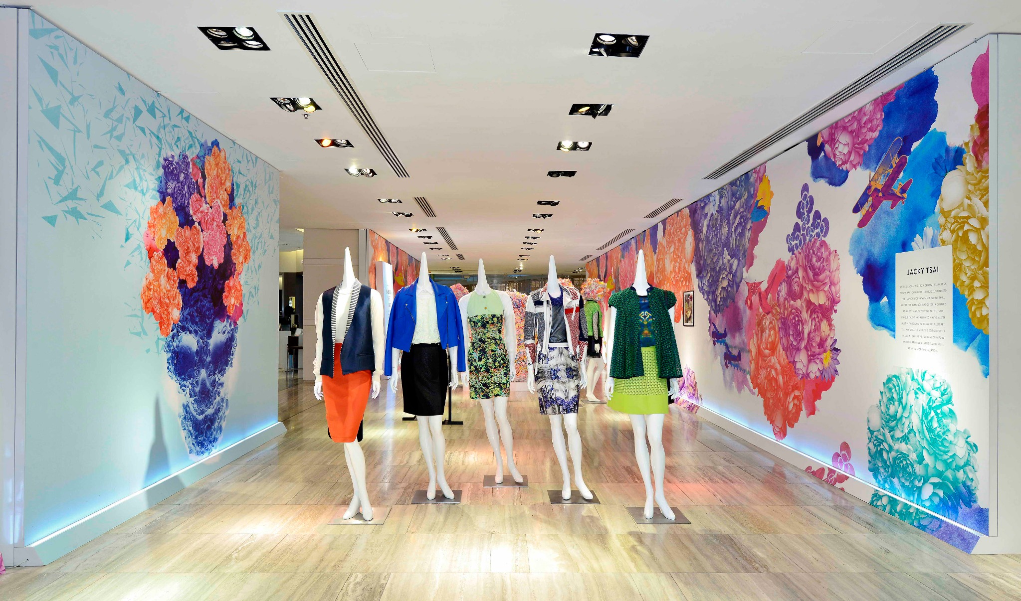 Lane Crawford Fashion Meets Art installation with garments framed by Jacky Tsai’s large-scale floral skull wall graphics