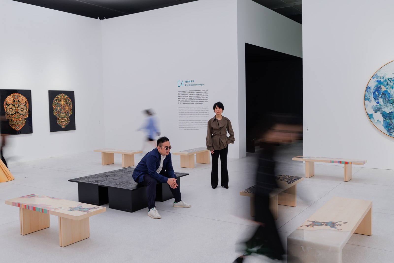 The art benches in use, surrounded by works from the exhibition.