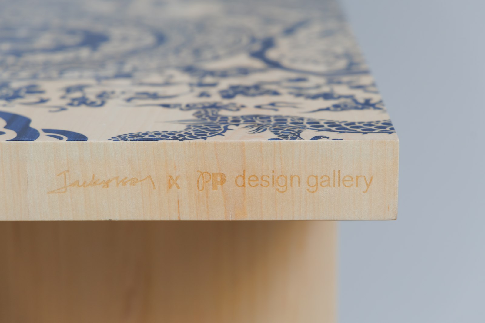 The collaboration’s signature, engraved into the edge of a bench.